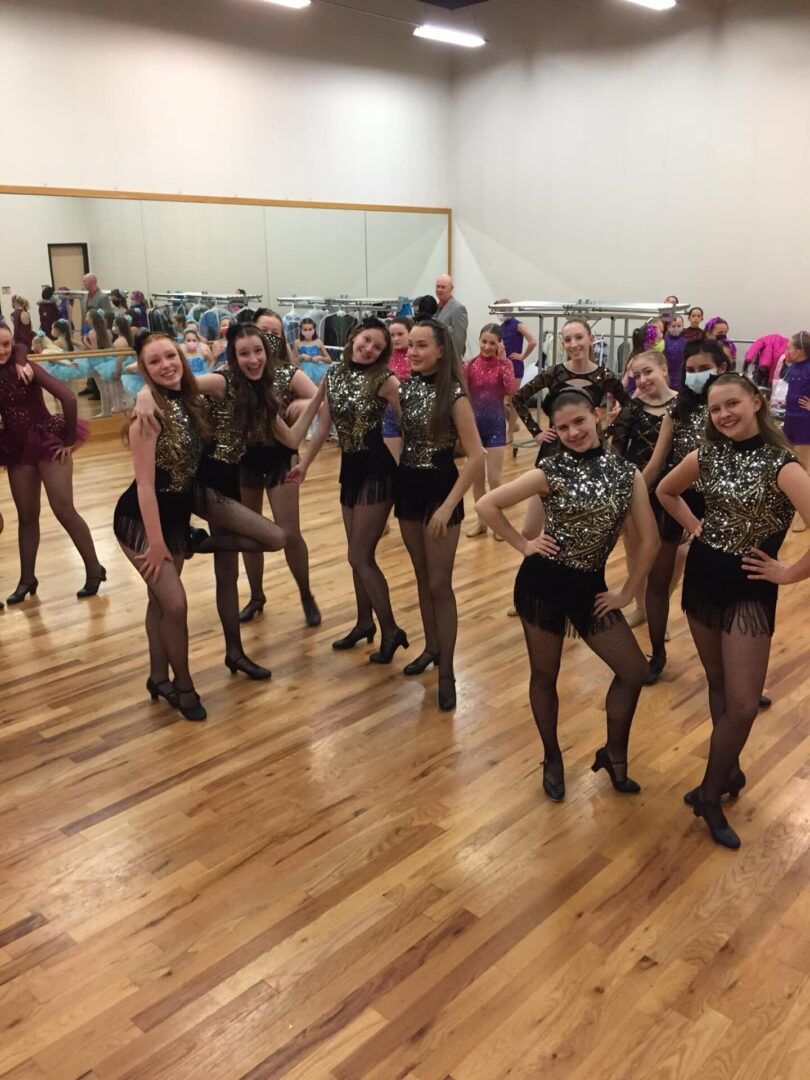 A group of women in black and leopard print outfits.