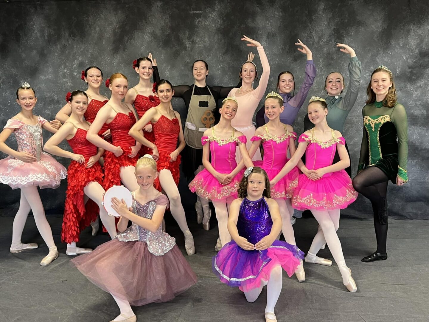A group of young ballerinas posing for a picture.